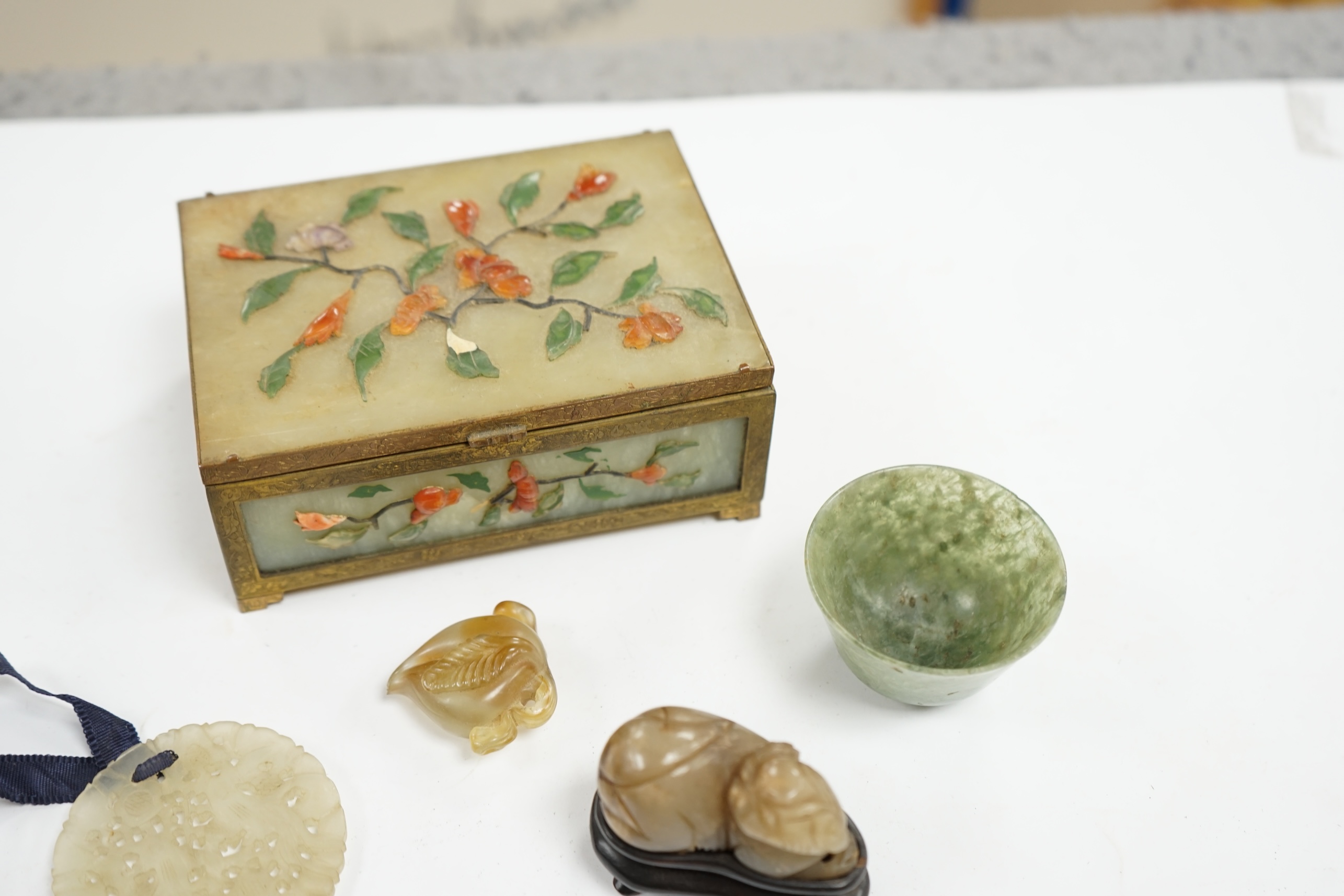 A group of Chinese jade and hardstone carvings to include a cigarette box & cover and a 14K mounted Yamanaka & Co pouch, largest 13cm wide. Condition - mostly fair